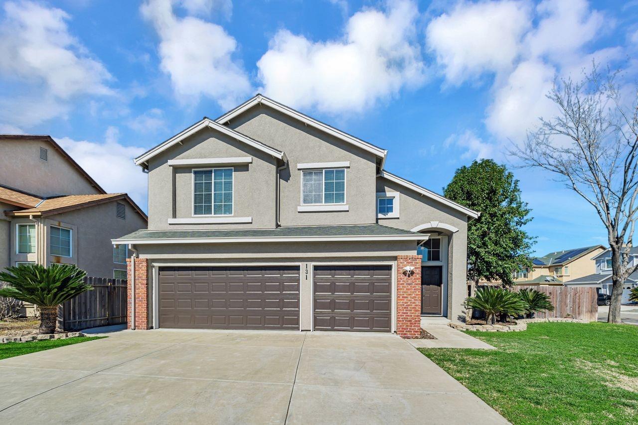 131 Cairo Court Tracy, CA 95376 - Photo 1 of 1 a front view of a house with a yard and garage