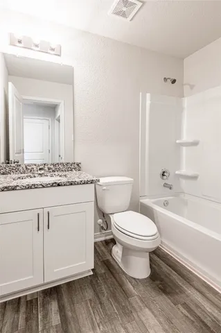 a bathroom with a toilet a sink and bathtub