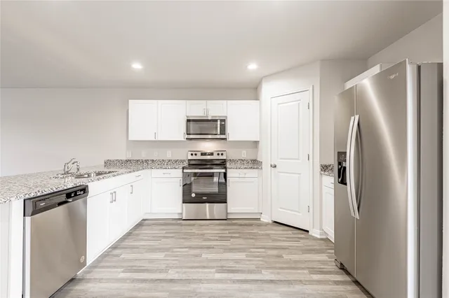 a kitchen with a refrigerator stove and sink