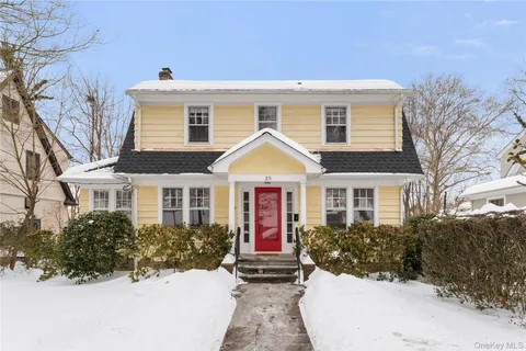 a view of house with yard and sitting area
