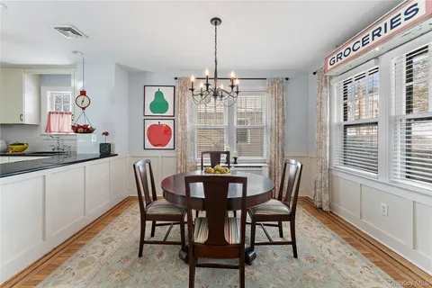 a view of a dining room with furniture wooden floor and chandelier
