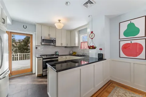 a kitchen that has a lot of cabinets and wooden floor