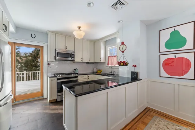 a kitchen that has a lot of cabinets and wooden floor