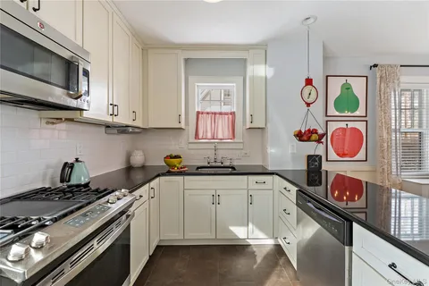 a kitchen with stainless steel appliances granite countertop a stove and a microwave