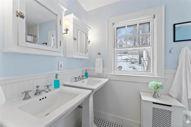 a view of cabinets a sink and wooden floor