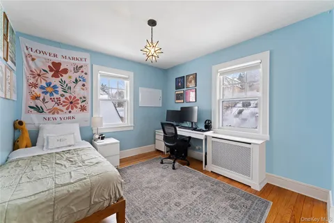 a bedroom that has a bed and a desk in it