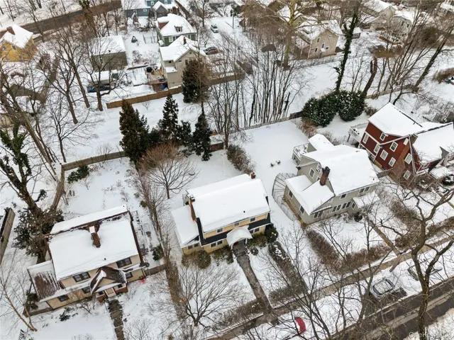 a view of backyard of a house with outdoor seating