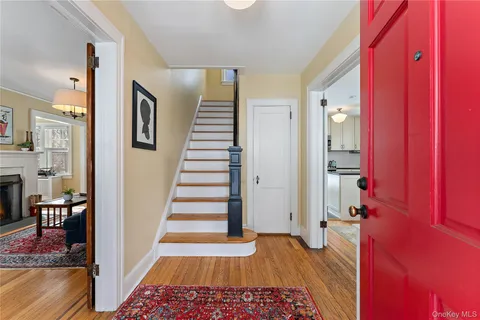 a view of a hallway with wooden floor and staircase