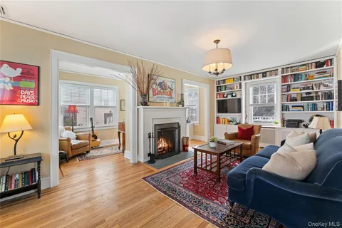 a living room with furniture large window and a fireplace