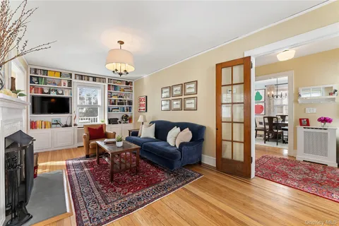 a living room with furniture a flat screen tv and a table