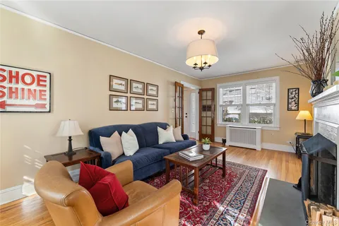 a living room with furniture a dining table and a bookshelf