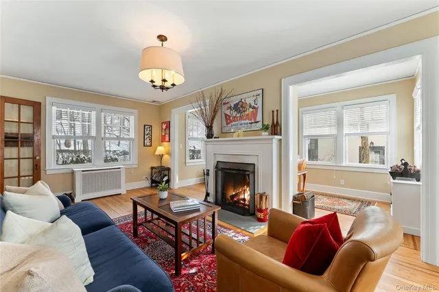 a living room with furniture chandelier and a fireplace