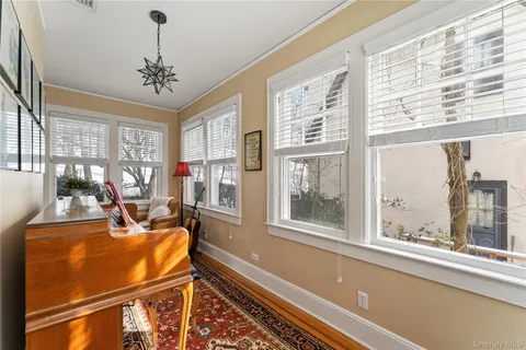 a view of a dining room with furniture a chandelier and wooden floor