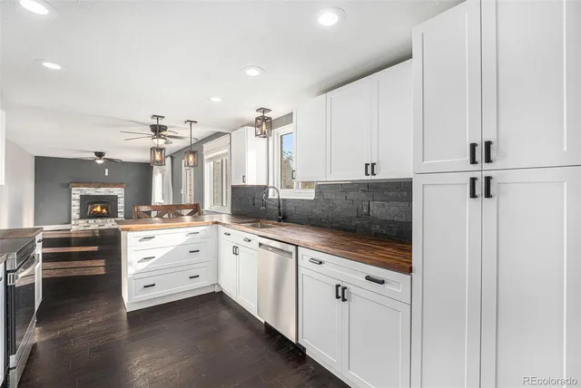 a large white kitchen with cabinets