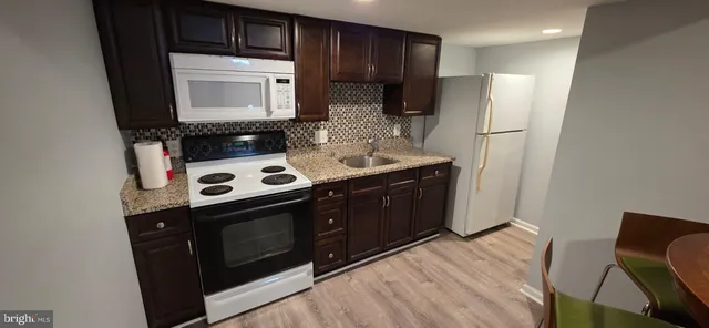a kitchen with stainless steel appliances a stove a microwave and a refrigerator