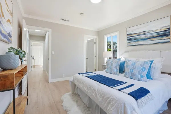 a bedroom with a bed and wooden floor