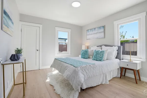 a bedroom with a bed and a potted plant