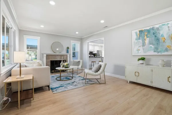 a living room with furniture a fireplace and a window