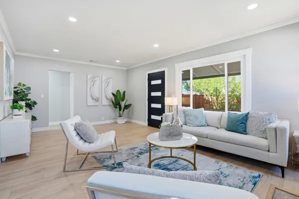 a living room with furniture and a potted plant