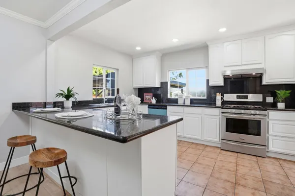 a kitchen with granite countertop a sink and appliances