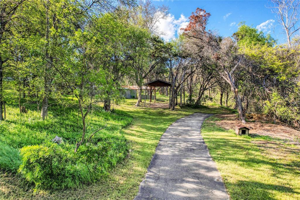 17234 West Reed Park Road Jonestown, TX 78645 - Photo 17 of 30 Driveway along creekside to our RV cover and old metal workshop