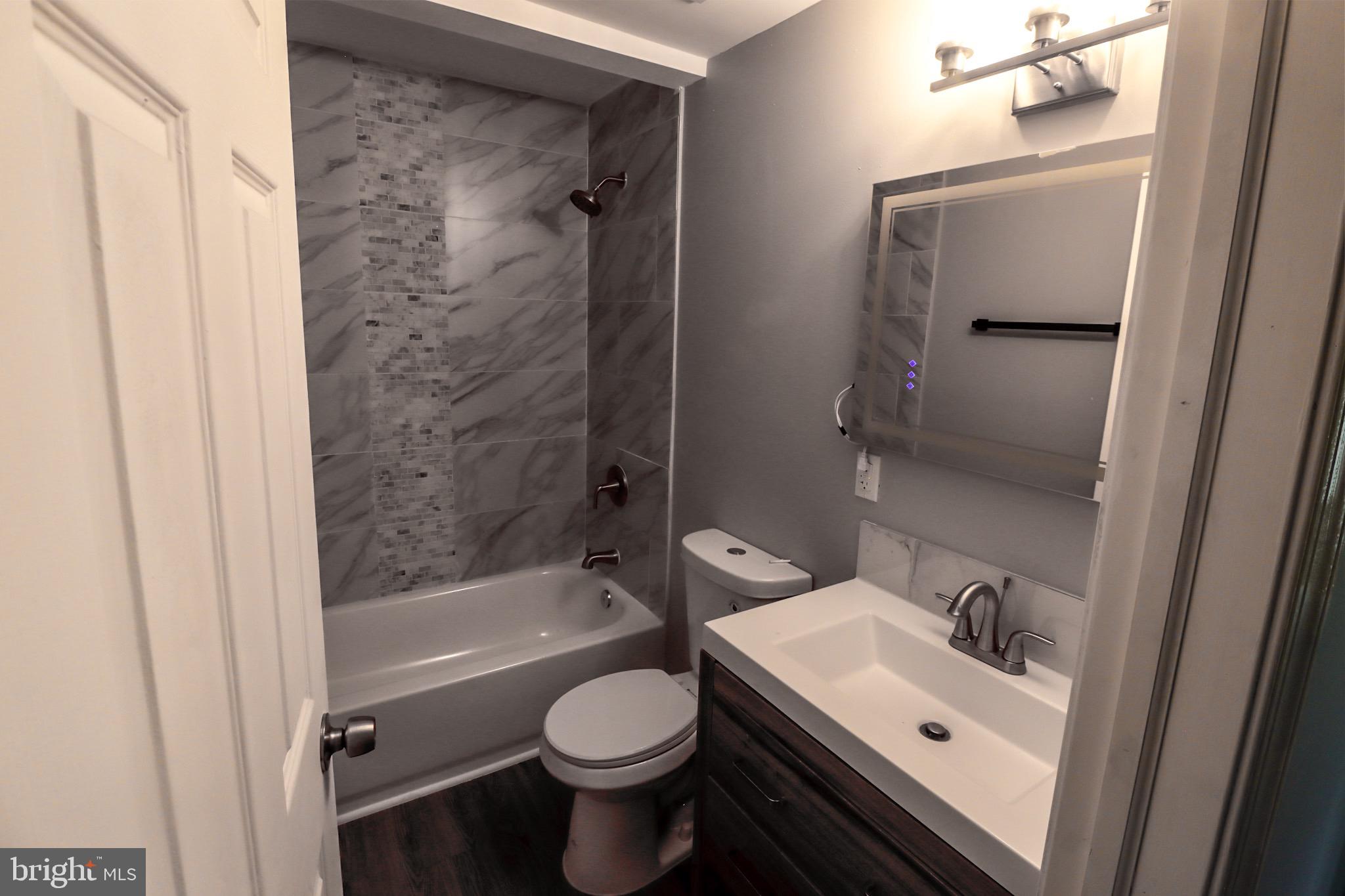 315 Riverside Drive Baltimore, MD 21221 - Photo 17 of 22 a bathroom with a sink toilet and shower