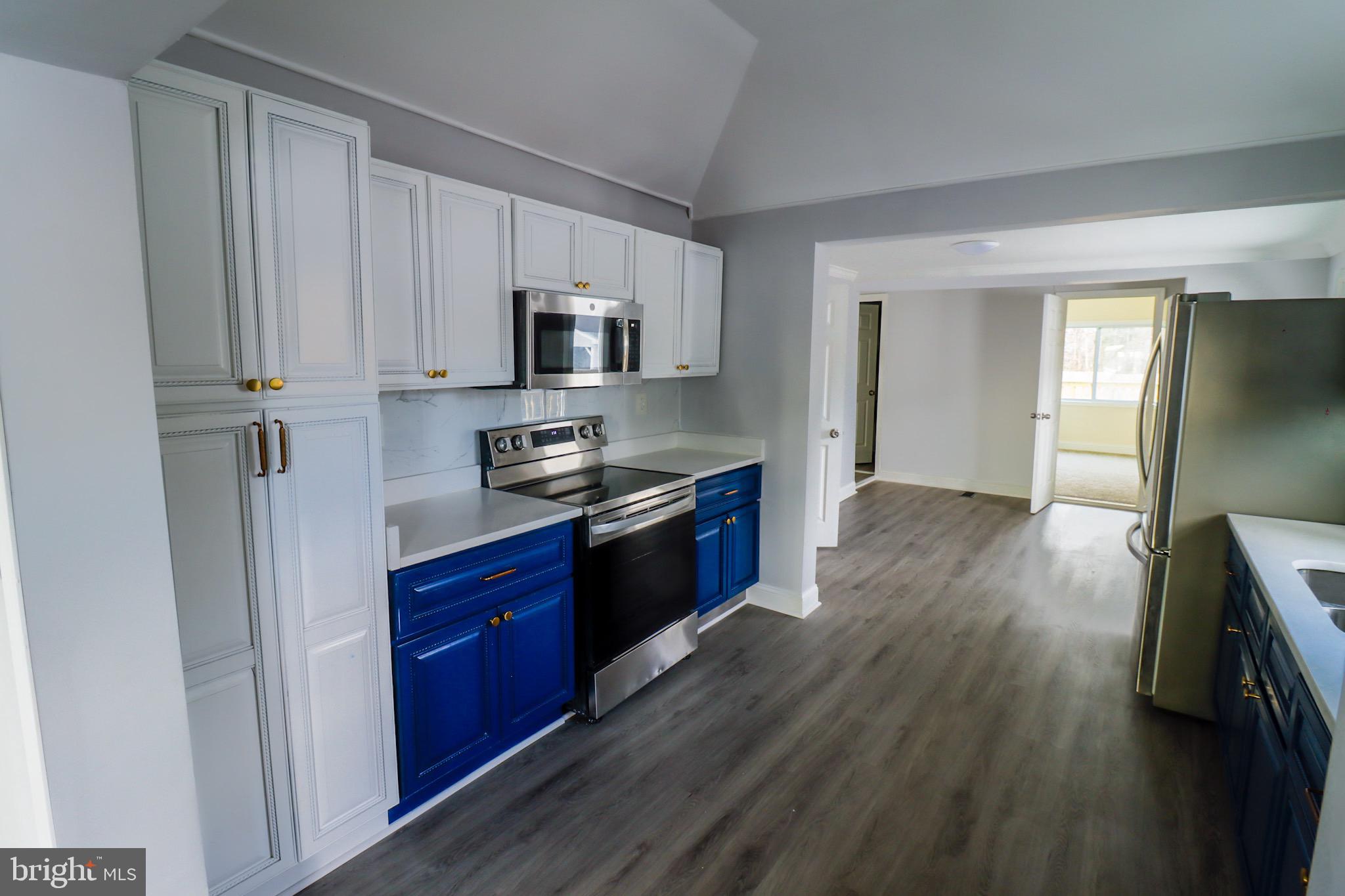 315 Riverside Drive Baltimore, MD 21221 - Photo 8 of 22 a kitchen with stainless steel appliances granite countertop a stove a sink and a refrigerator