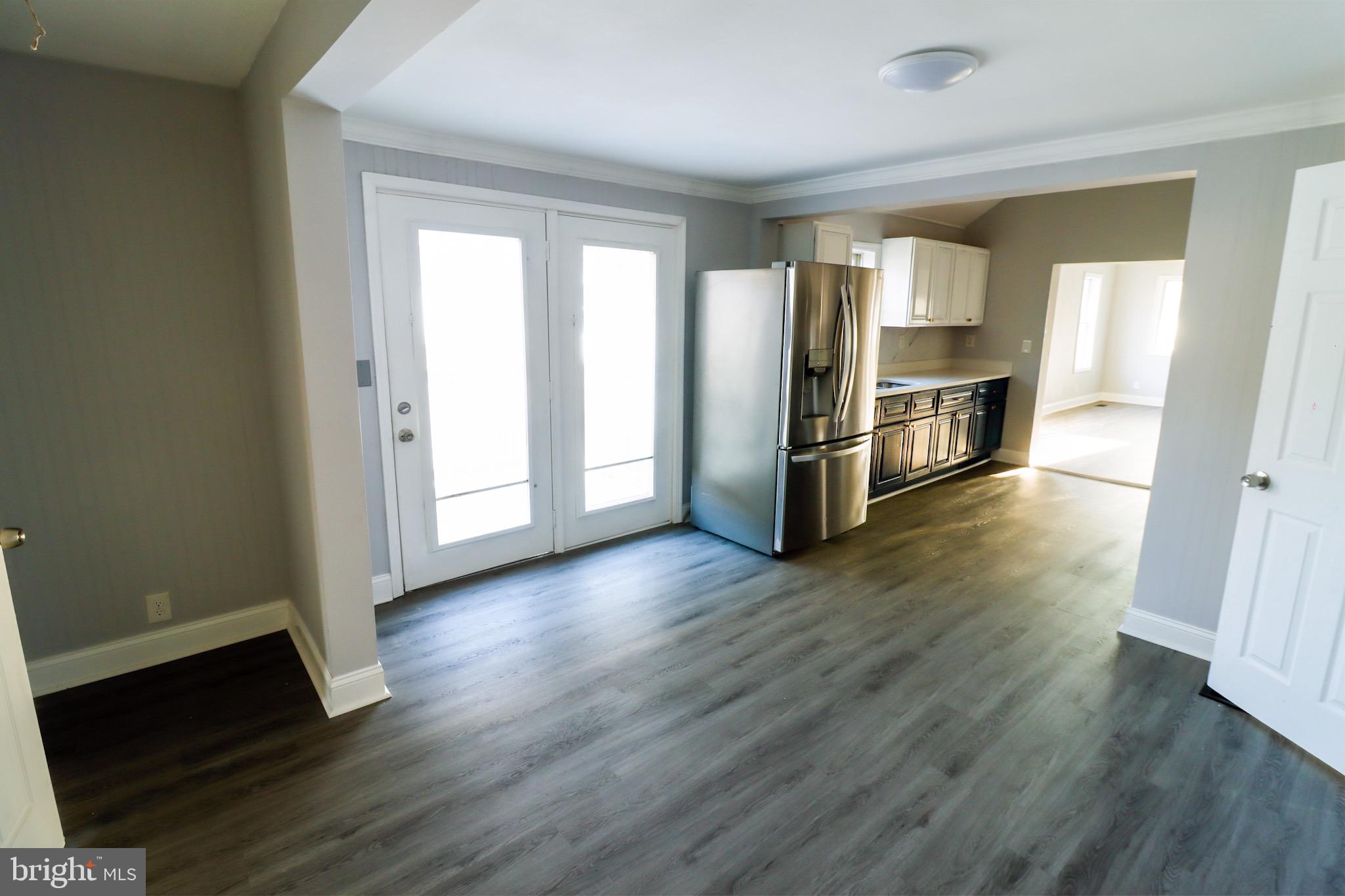 315 Riverside Drive Baltimore, MD 21221 - Photo 10 of 22 a view of a kitchen with wooden floor and electronic appliances