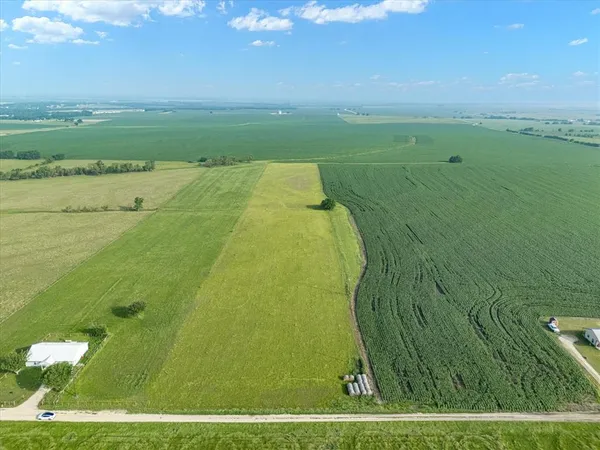a view of a field with an ocean view