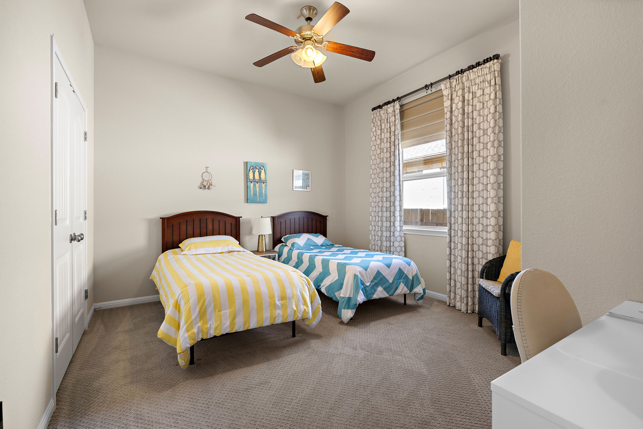5016 Yucca Flower Lane Georgetown, TX 78626 - Photo 24 of 31 a spacious bedroom with two beds and a chandelier