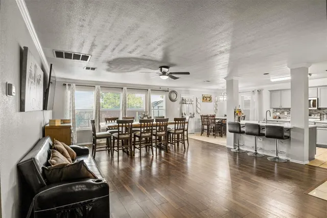 a view of a dining room with furniture window and wooden floor