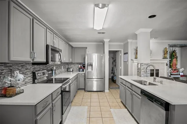 a kitchen with stainless steel appliances a sink stove and cabinets