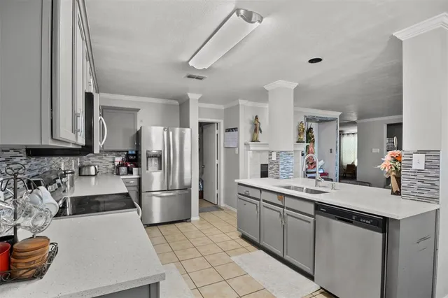 a kitchen with a sink appliances and cabinets