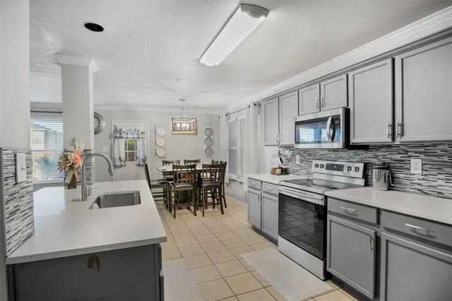 a kitchen with appliances a sink and cabinets
