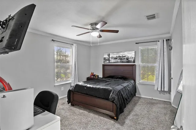 a bedroom with a bed a couch and a window