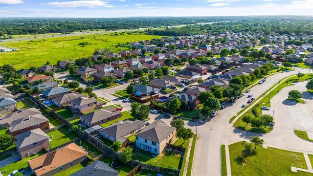 an aerial view of residential houses with outdoor space and swimming pool