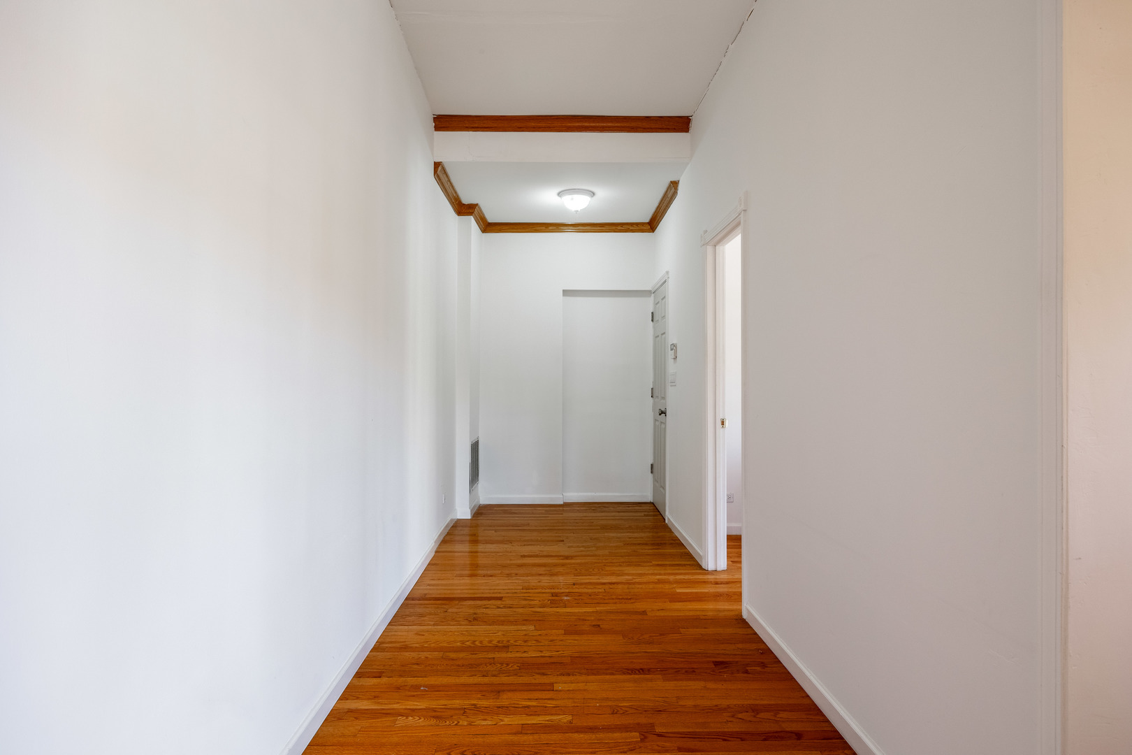 3107 North Harding Avenue, Unit 2W Chicago, IL 60618 - Photo 12 of 14 a view of a hallway with wooden floor