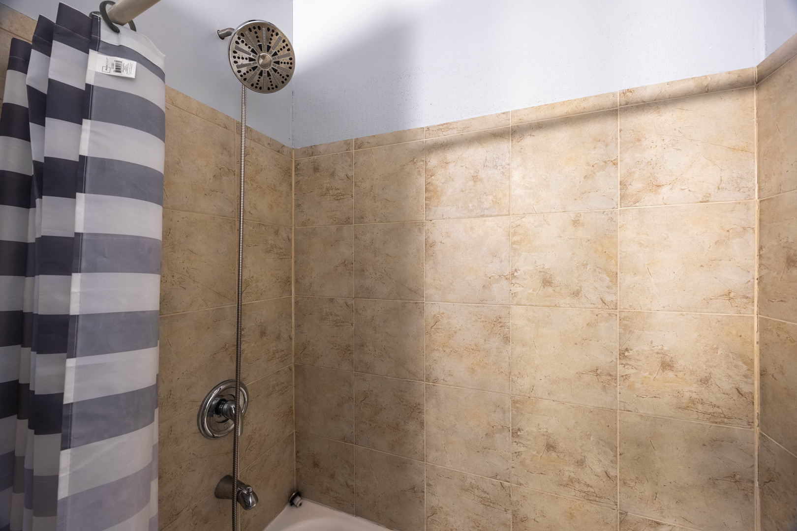 3107 North Harding Avenue, Unit 2W Chicago, IL 60618 - Photo 14 of 14 a bathroom with a shower and a shower curtain
