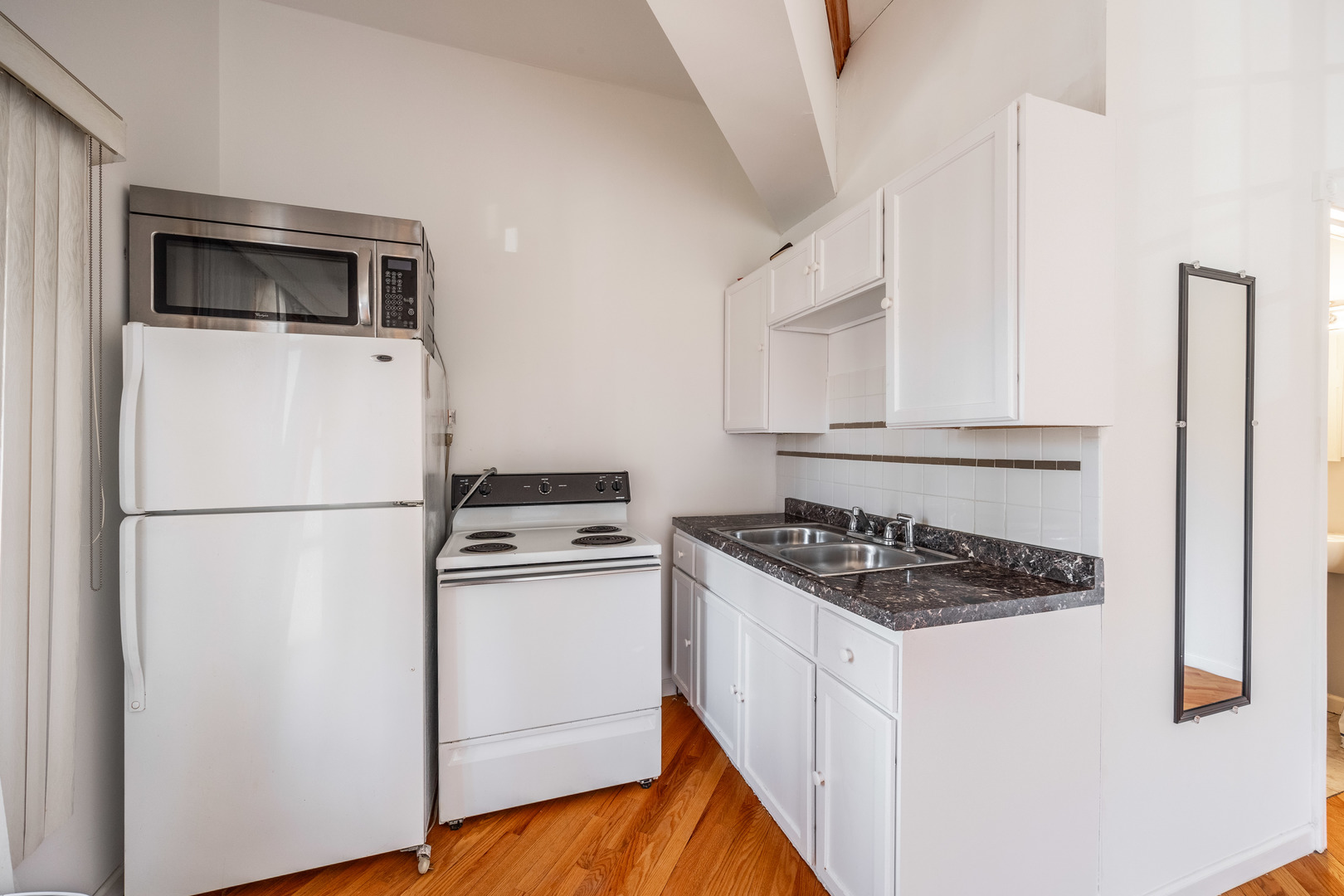 3107 North Harding Avenue, Unit 2W Chicago, IL 60618 - Photo 2 of 14 a white refrigerator freezer sitting inside of a kitchen
