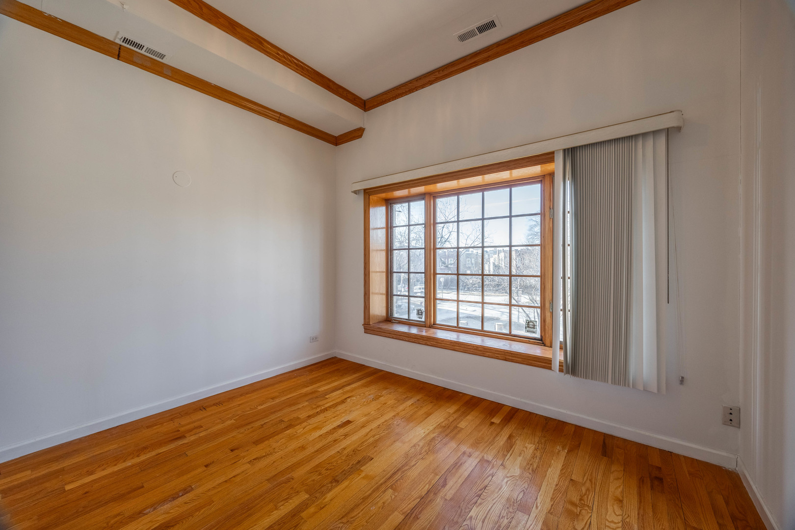 3107 North Harding Avenue, Unit 2W Chicago, IL 60618 - Photo 7 of 14 a view of empty room with wooden floor and fan