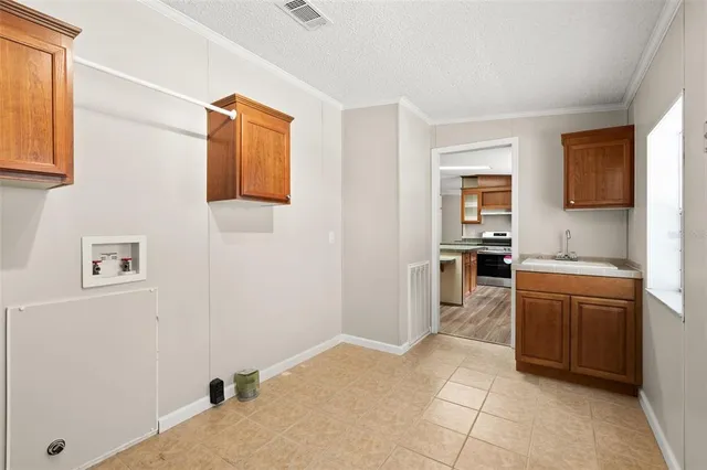 a large white kitchen with cabinets