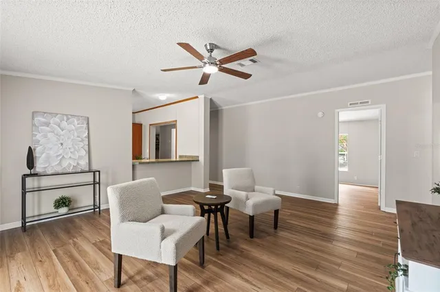 a living room with furniture and wooden floor