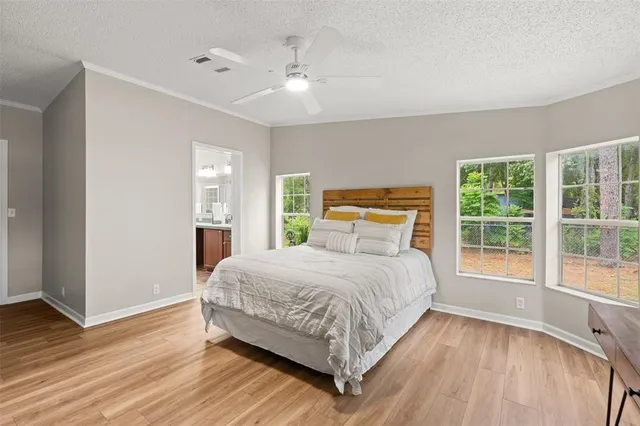 a bedroom with a large bed and a large window