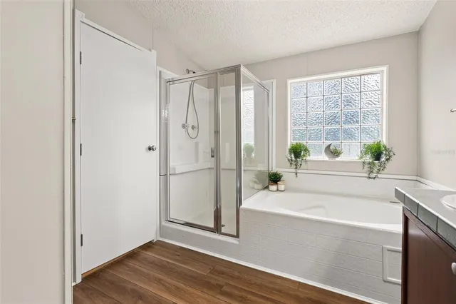 a bathroom with a bathtub a sink and a window