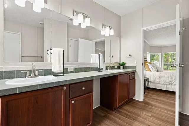 a spacious bathroom with a double vanity sink and a mirror