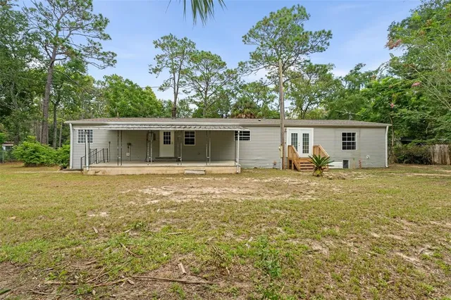 a front view of house with yard and trees