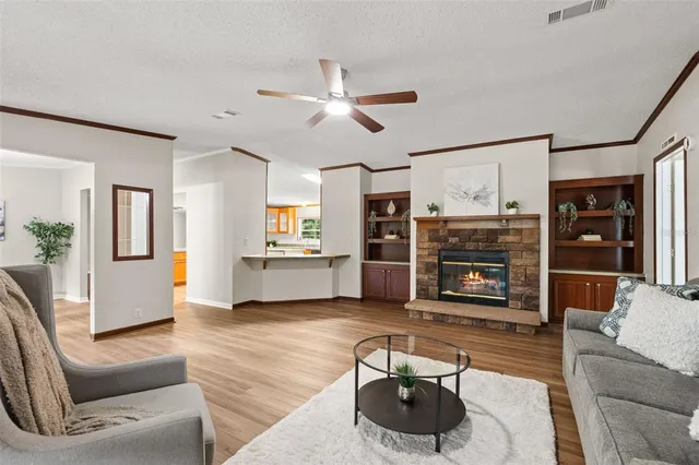 a living room with furniture and a kitchen