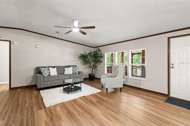 a living room with furniture and wooden floor