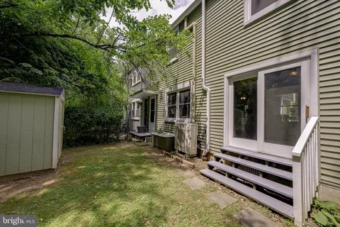 a view of a house with backyard and porch