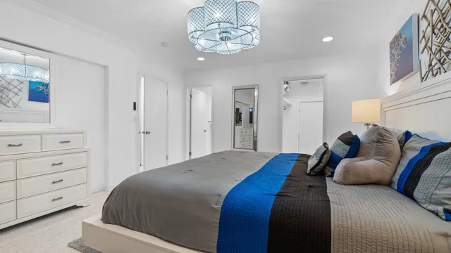 a bed room with a bed and a chandelier